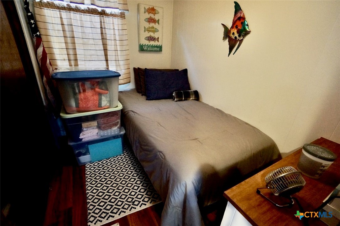 513 16th Street Port O'Connor, TX 77982 - Photo 23 of 35 a bedroom with a bed and a window