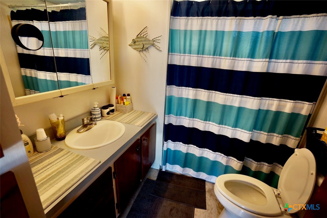 513 16th Street Port O'Connor, TX 77982 - Photo 24 of 35 a bathroom with a sink and a mirror