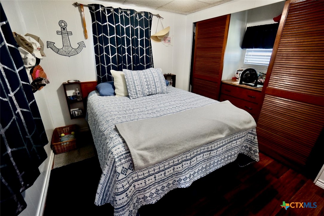 513 16th Street Port O'Connor, TX 77982 - Photo 25 of 35 a bedroom with a bed and walk in closet