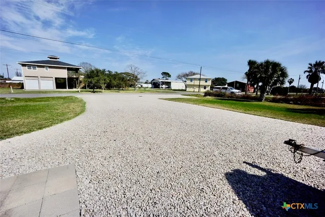 a view of outdoor space with garden and car parked