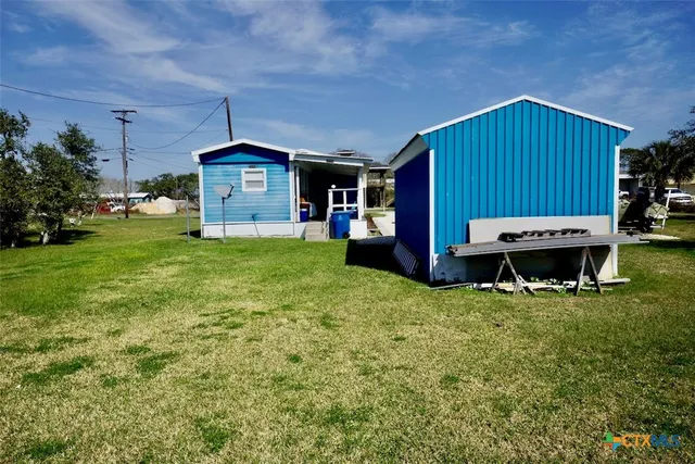 a view of a backyard with a tub and trees