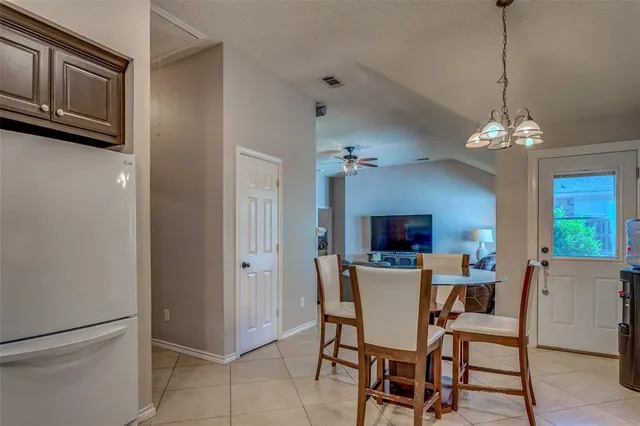 a view of a dining room with furniture and a chandelier