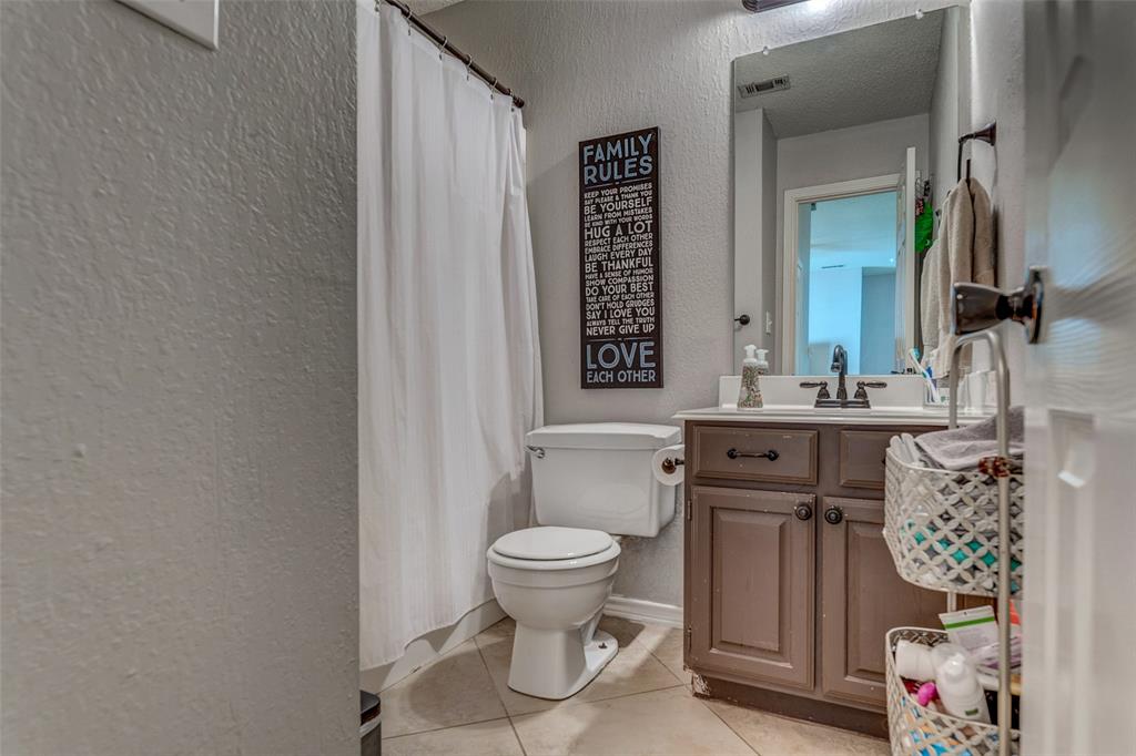 11812 Canoe Road Frisco, TX 75035 - Photo 25 of 31 a bathroom with a toilet sink and mirror