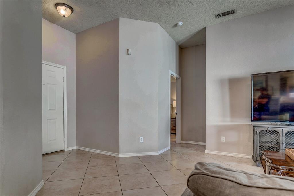 11812 Canoe Road Frisco, TX 75035 - Photo 4 of 31 a view of a livingroom with furniture and a flat screen tv