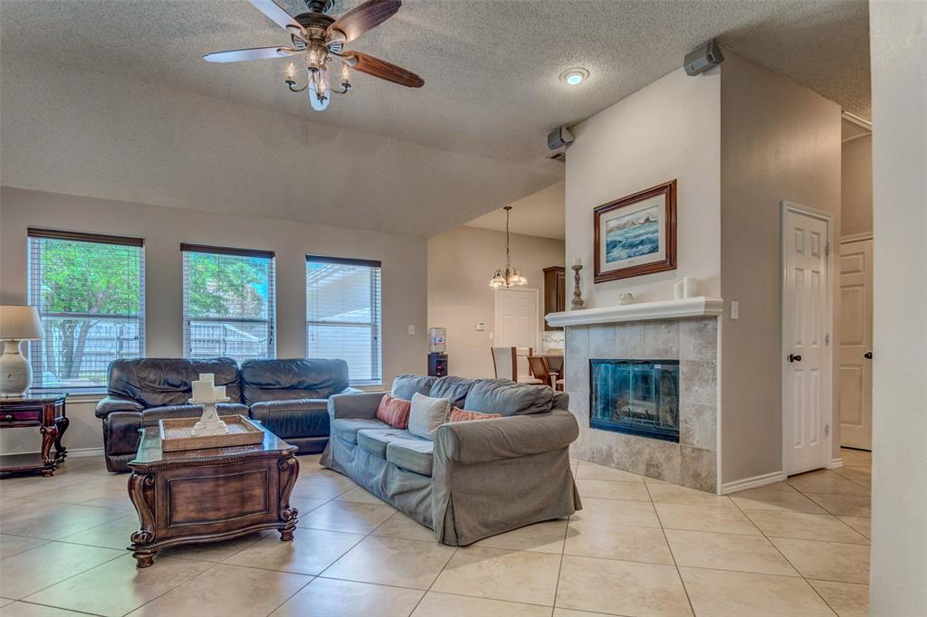 11812 Canoe Road Frisco, TX 75035 - Photo 5 of 31 a living room with furniture and a fireplace