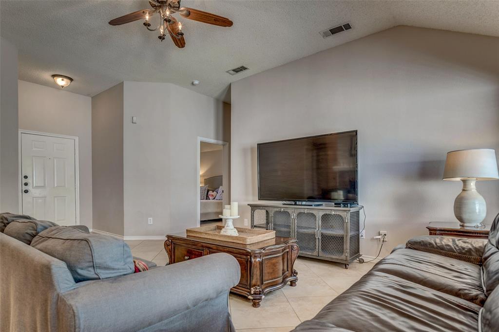11812 Canoe Road Frisco, TX 75035 - Photo 6 of 31 a living room with furniture and a flat screen tv