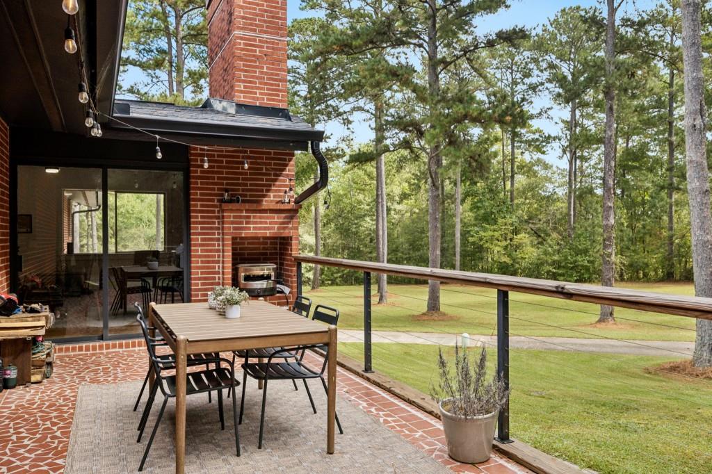 334 Luther Bailey Road Senoia, GA 30276 - Photo 11 of 67 a view of a chairs and table in the balcony