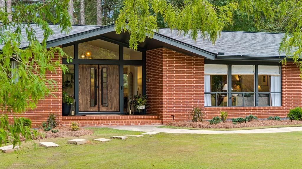 334 Luther Bailey Road Senoia, GA 30276 - Photo 15 of 67 a view of a house with a small yard plants and large tree