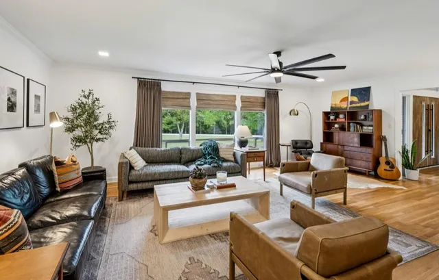 a living room with furniture and a large window