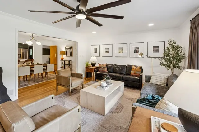 a large kitchen with kitchen island a large window a sink and stainless steel appliances