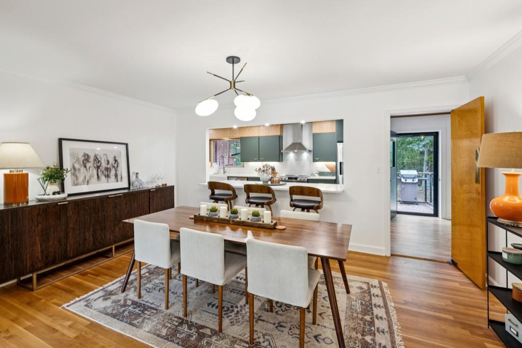 334 Luther Bailey Road Senoia, GA 30276 - Photo 3 of 67 a view of a dining room with furniture wooden floor and a rug