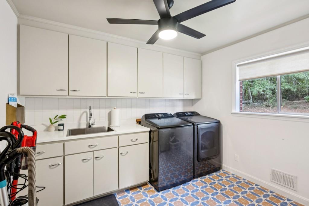 334 Luther Bailey Road Senoia, GA 30276 - Photo 32 of 67 a kitchen with stainless steel appliances kitchen island granite countertop a sink window and cabinets
