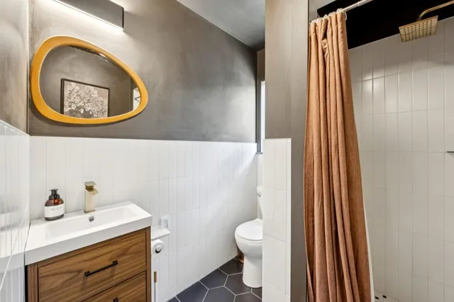 a bedroom with a large bed couch and a window