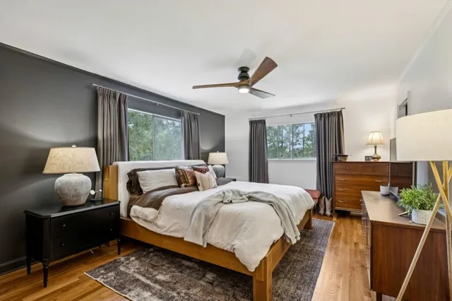 a bed room with two bed and a window