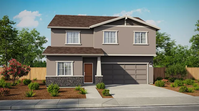 a front view of a house with garage and plants