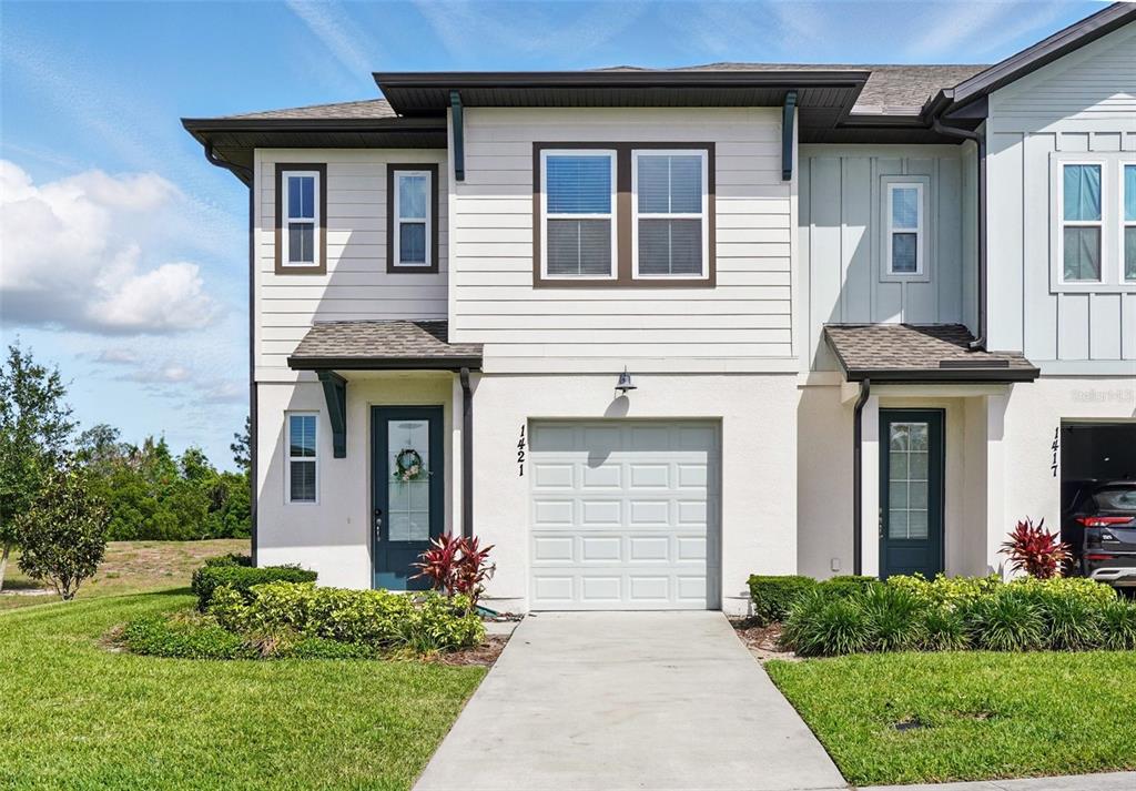 1421 Discovery Street Davenport, FL 33896 - Photo 1 of 44 a front view of a house with garden