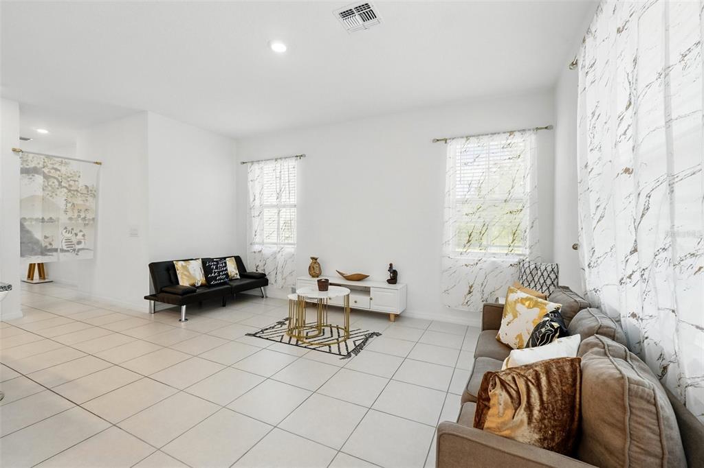 1421 Discovery Street Davenport, FL 33896 - Photo 14 of 44 a living room with furniture and a large window