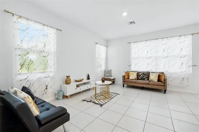 a kitchen with stainless steel appliances kitchen island granite countertop a sink and a refrigerator