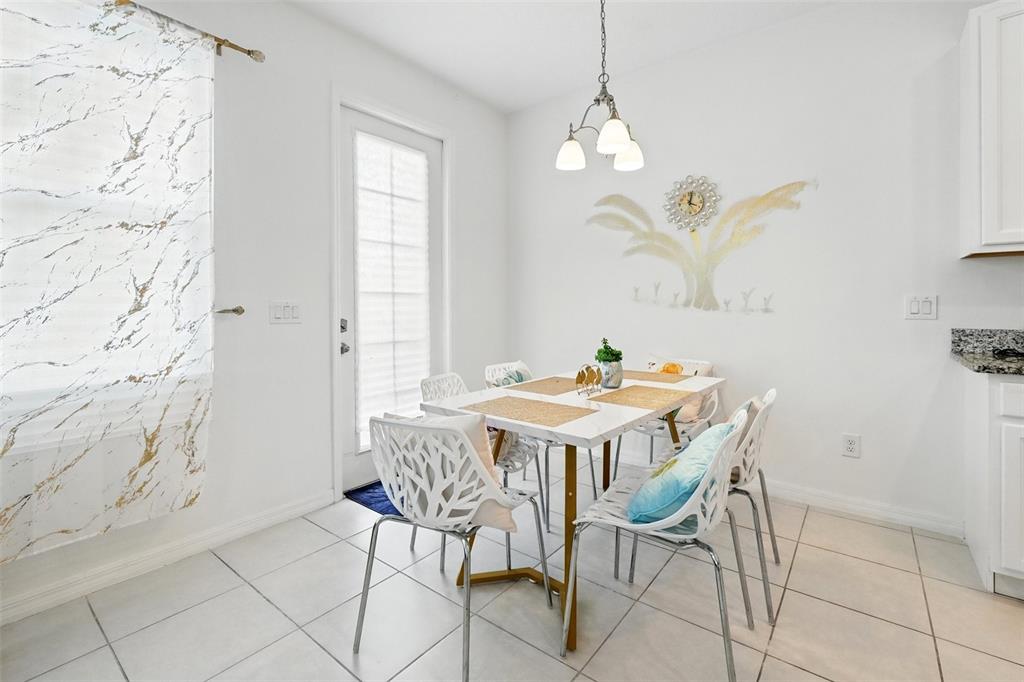 1421 Discovery Street Davenport, FL 33896 - Photo 18 of 44 a view of a dining room with furniture and chandelier