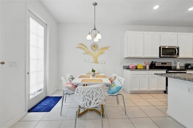a living room with furniture kitchen view and a large window