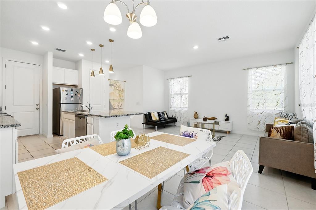 1421 Discovery Street Davenport, FL 33896 - Photo 20 of 44 a living room with furniture kitchen view and a large window