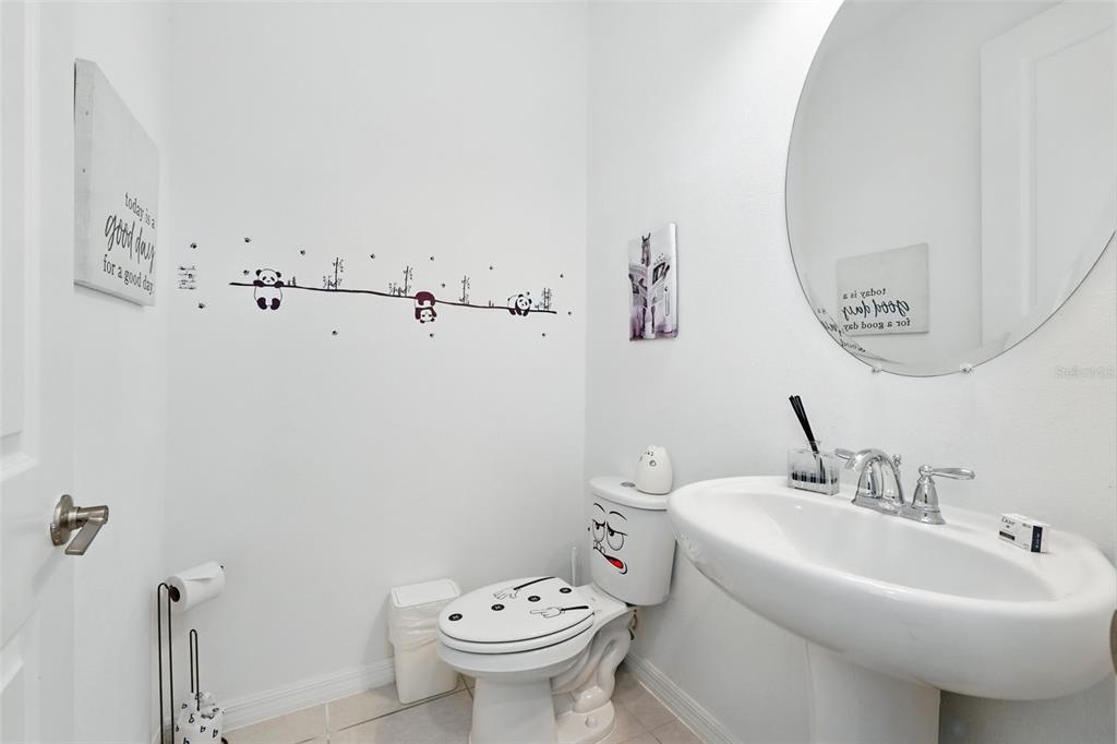 1421 Discovery Street Davenport, FL 33896 - Photo 21 of 44 a bathroom with a sink and mirror with toilet