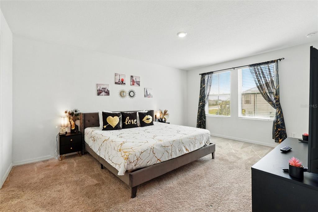 1421 Discovery Street Davenport, FL 33896 - Photo 23 of 44 a bedroom with a bed and window