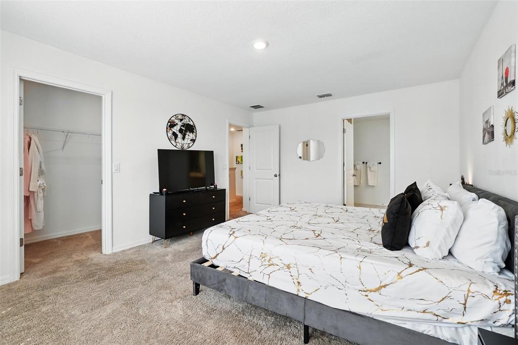 1421 Discovery Street Davenport, FL 33896 - Photo 24 of 44 a bedroom with a bed and a television