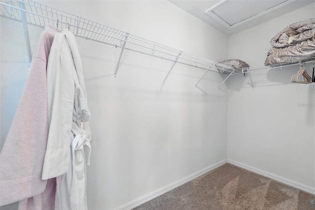1421 Discovery Street Davenport, FL 33896 - Photo 27 of 44 a view of walk in closet with clothes