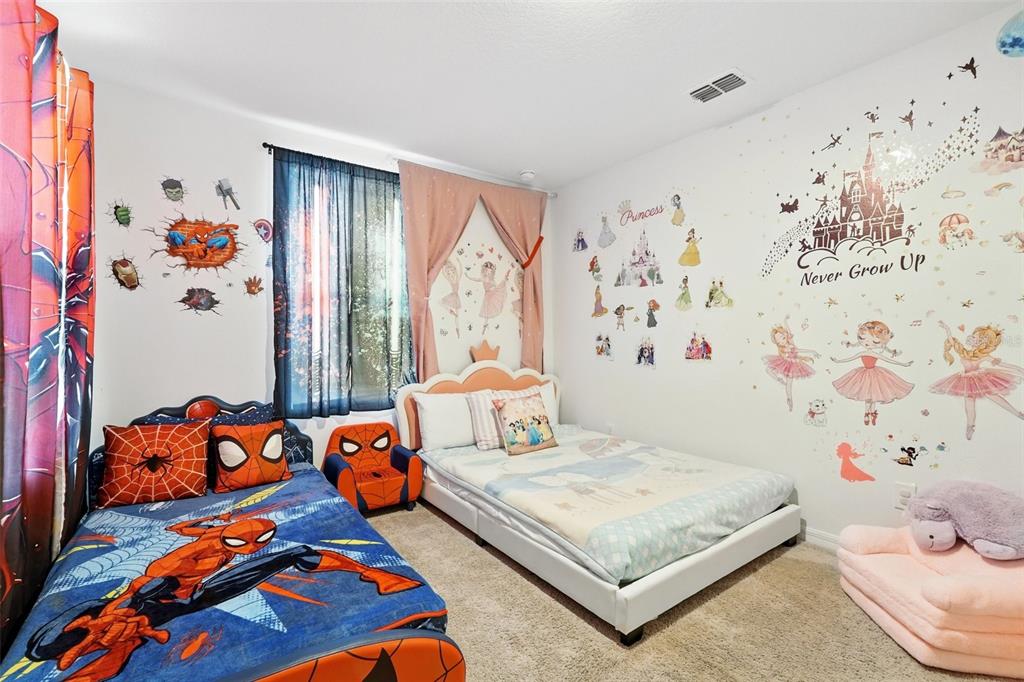 1421 Discovery Street Davenport, FL 33896 - Photo 28 of 44 a bedroom with a bed and window