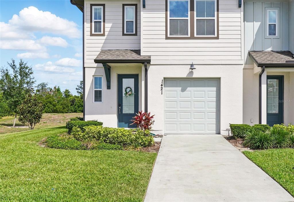 1421 Discovery Street Davenport, FL 33896 - Photo 3 of 44 a front view of a house with garden