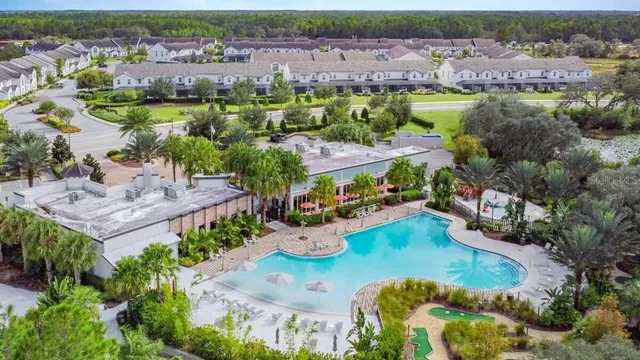a view of a lake with a table and chairs under an umbrella