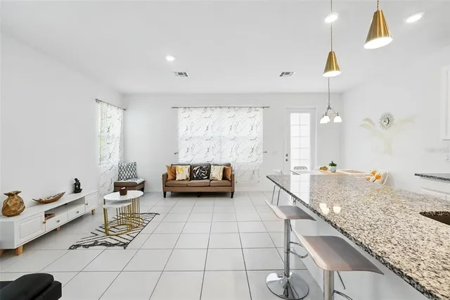 a kitchen with stainless steel appliances kitchen island granite countertop a sink and cabinets
