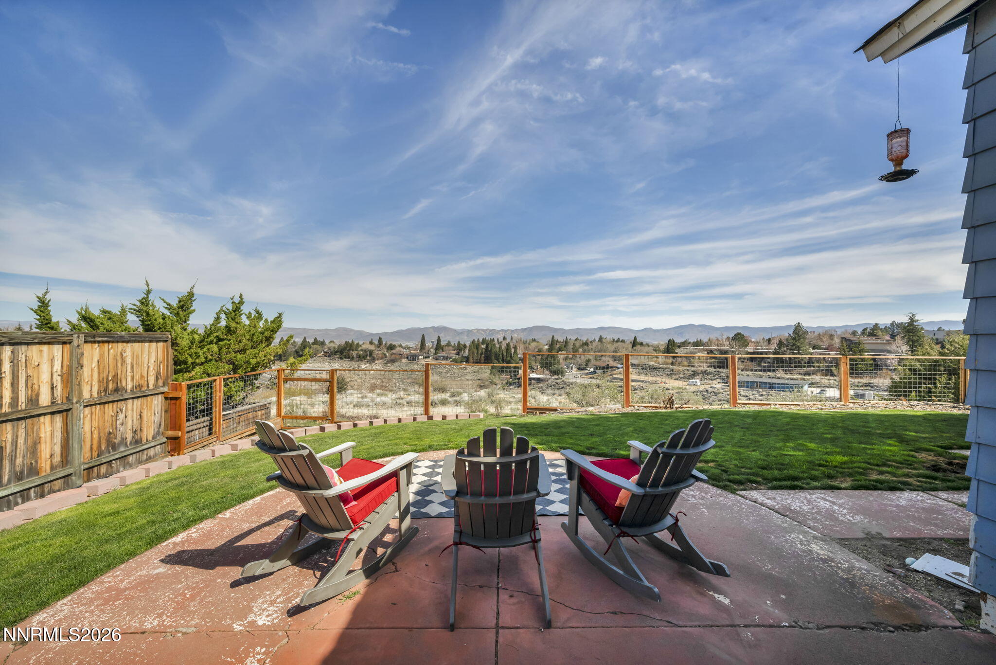 3332 Skyline View Drive Reno, NV 89509 - Photo 3 of 48 a bench sitting in the middle of a park with large trees