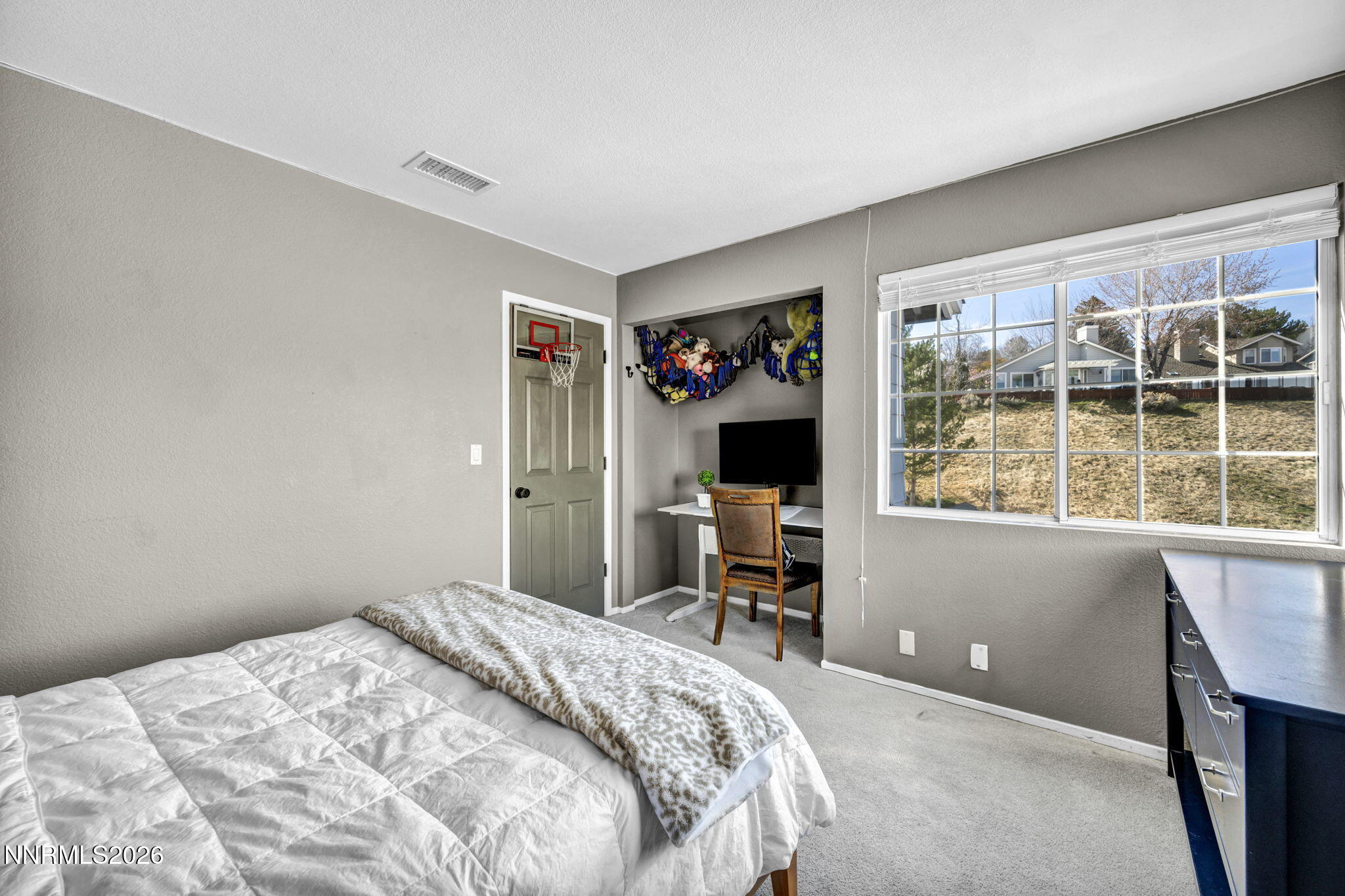 3332 Skyline View Drive Reno, NV 89509 - Photo 37 of 48 a bedroom with a bed and a flat tv screen next to a window