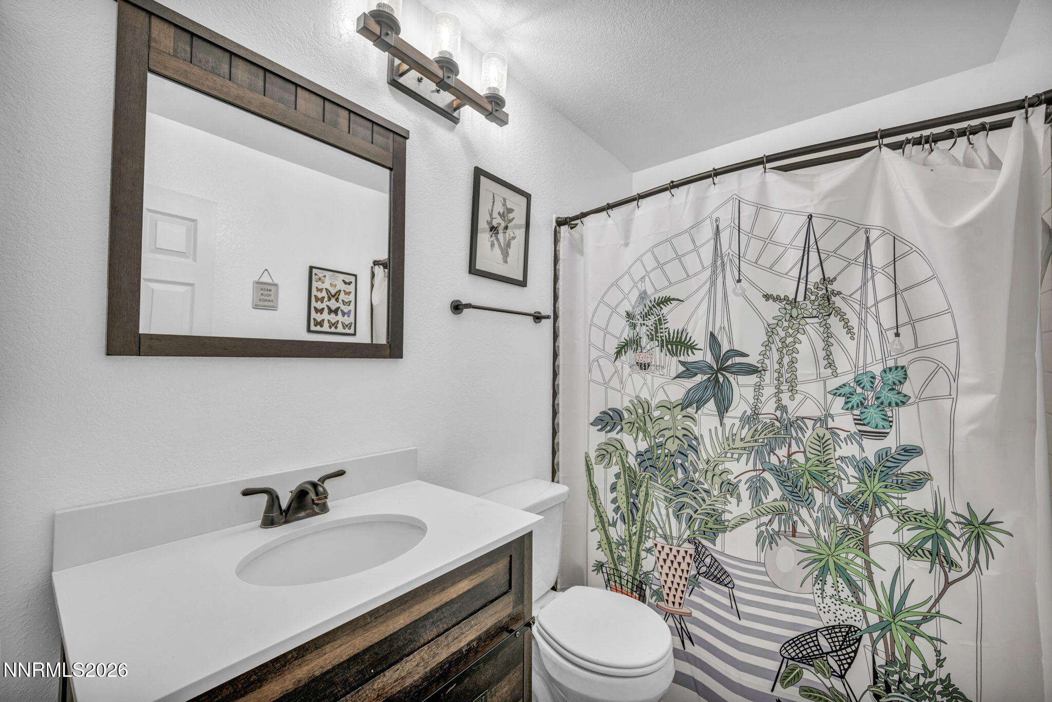 3332 Skyline View Drive Reno, NV 89509 - Photo 41 of 48 a bathroom with a sink a toilet and shower curtain