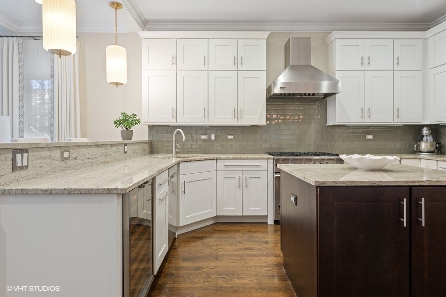 1248 West Grace Street, Unit 1 Chicago, IL 60613 - Photo 11 of 35 a kitchen with granite countertop a sink a stove and cabinets