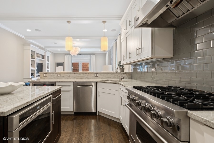 1248 West Grace Street, Unit 1 Chicago, IL 60613 - Photo 12 of 35 a kitchen with a stove a sink and wooden floor