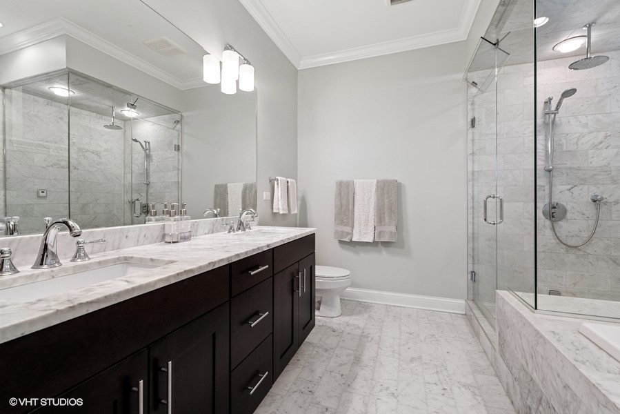 1248 West Grace Street, Unit 1 Chicago, IL 60613 - Photo 22 of 35 a bathroom with a double vanity sink mirror and shower