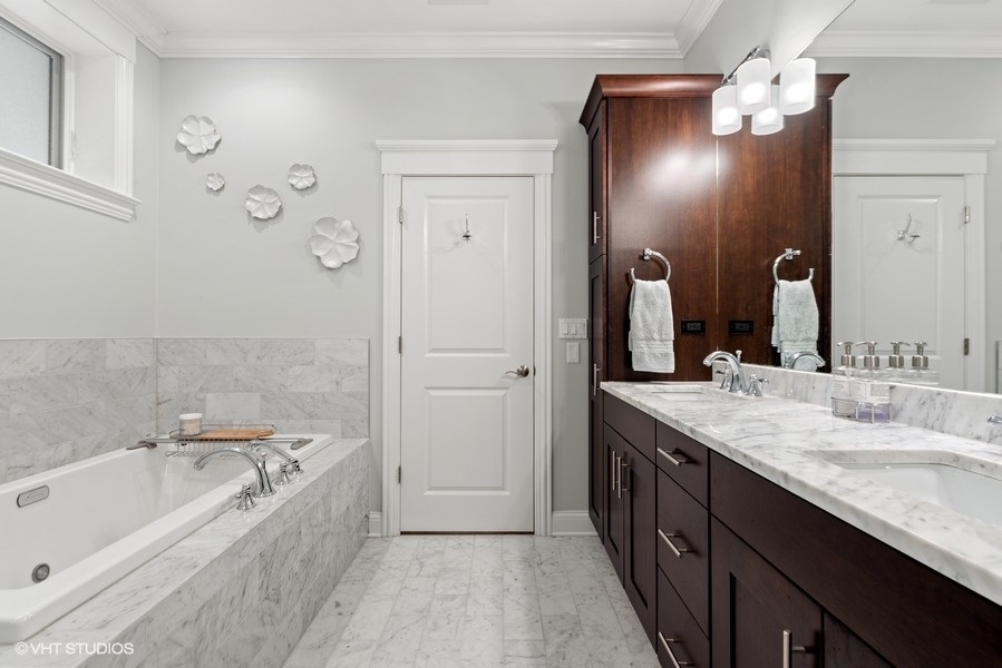 1248 West Grace Street, Unit 1 Chicago, IL 60613 - Photo 23 of 35 a bathroom with a bathtub double vanity sink and a mirror