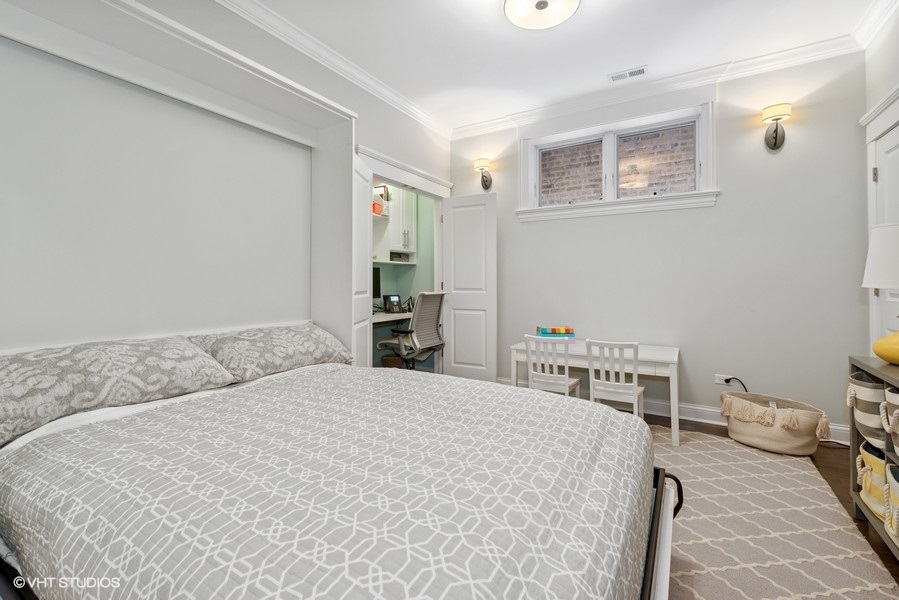 1248 West Grace Street, Unit 1 Chicago, IL 60613 - Photo 27 of 35 a bedroom with a bed and a table in it