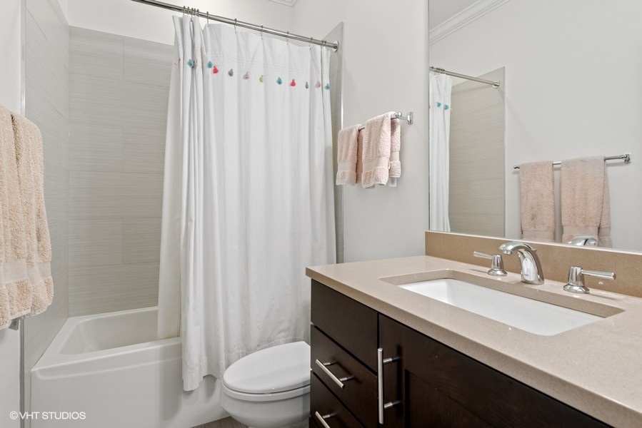 1248 West Grace Street, Unit 1 Chicago, IL 60613 - Photo 31 of 35 a bathroom with a sink a toilet and shower