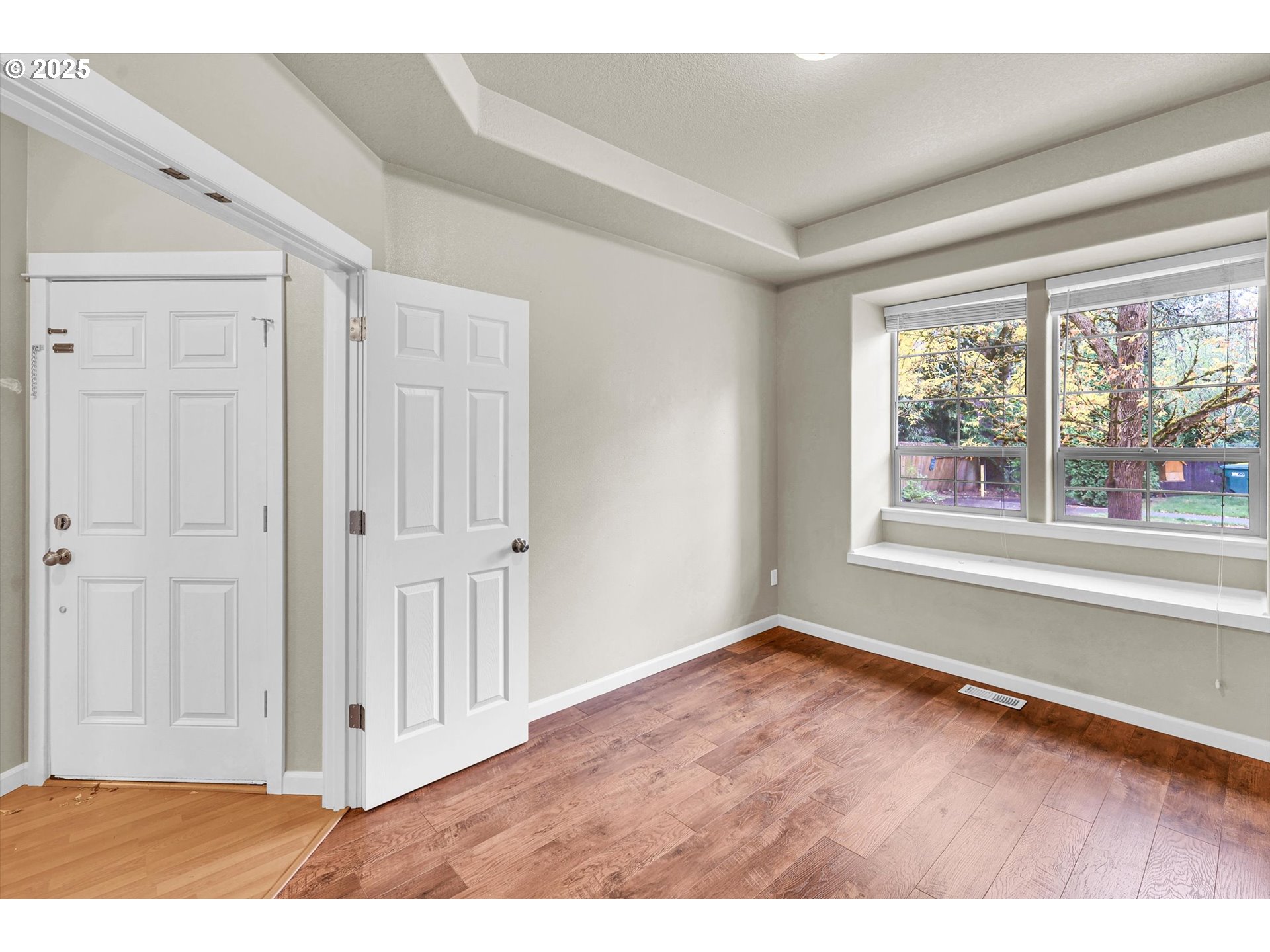 1892 Southwest Willowview Terrace Beaverton, OR 97003 - Photo 11 of 48 a view of an empty room with wooden floor and a window