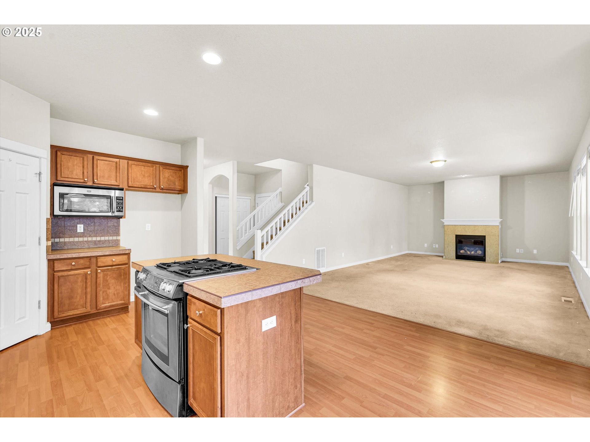 1892 Southwest Willowview Terrace Beaverton, OR 97003 - Photo 19 of 48 a kitchen that has a lot of cabinets in it and wooden floors