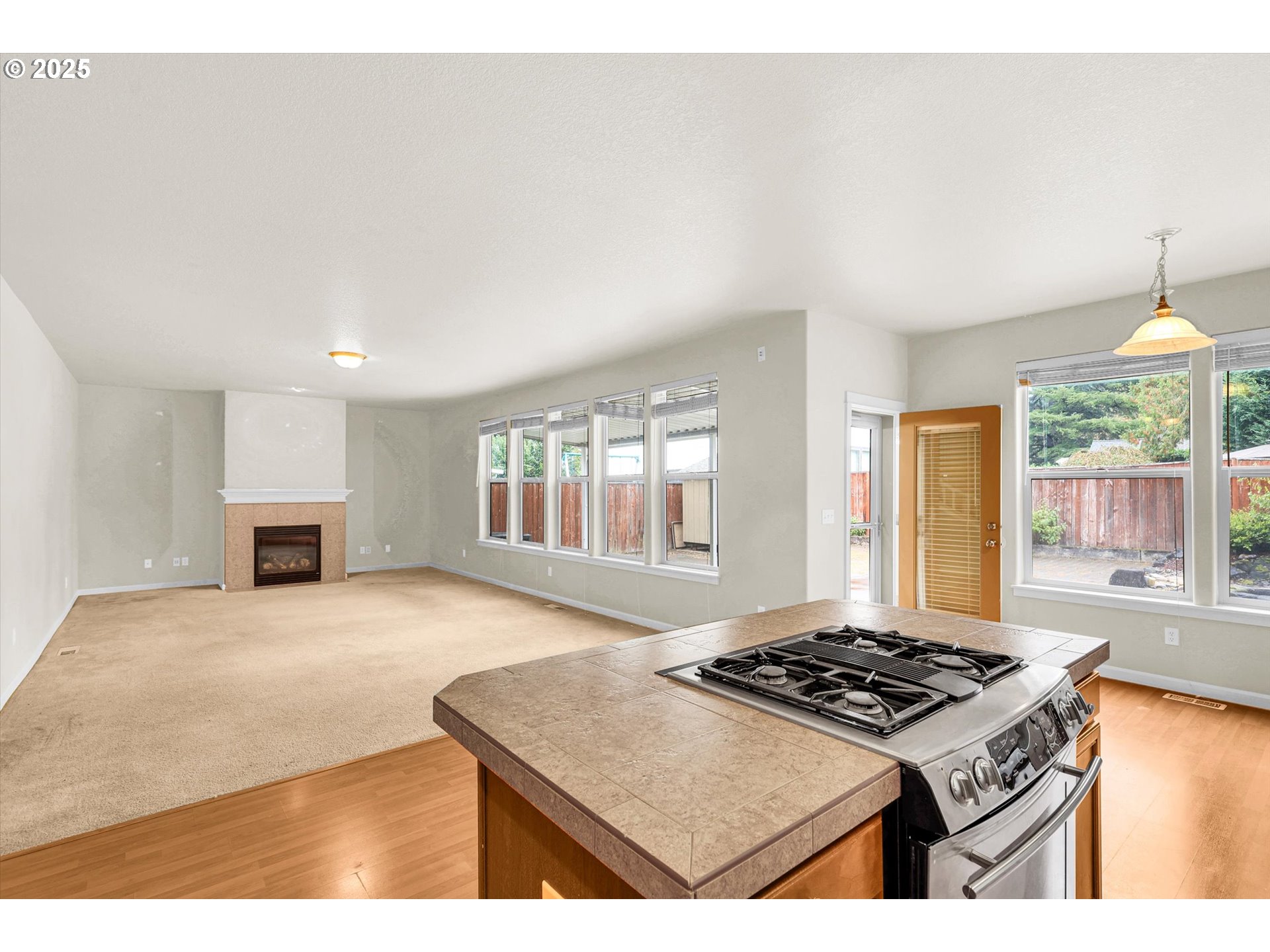 1892 Southwest Willowview Terrace Beaverton, OR 97003 - Photo 20 of 48 a kitchen with a stove a sink dishwasher and a refrigerator with wooden floor
