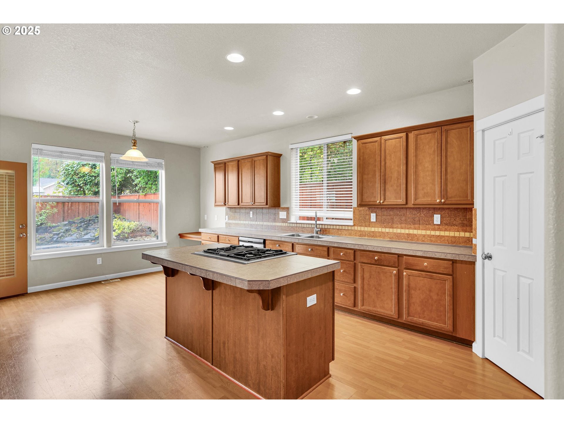 1892 Southwest Willowview Terrace Beaverton, OR 97003 - Photo 21 of 48 a kitchen with stainless steel appliances granite countertop a sink stove and wooden cabinets