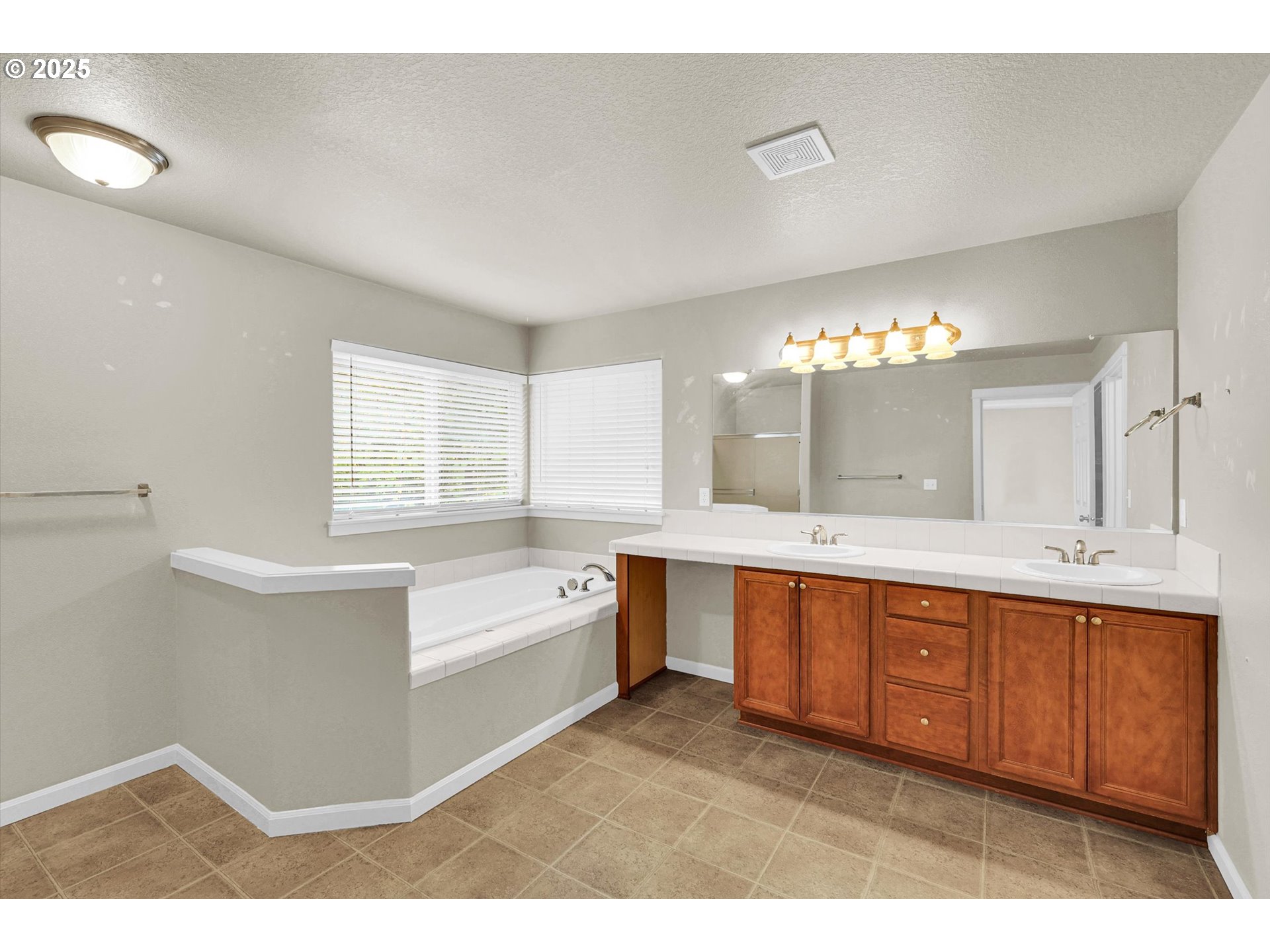 1892 Southwest Willowview Terrace Beaverton, OR 97003 - Photo 32 of 48 a large bathroom with a large tub sink and vanity