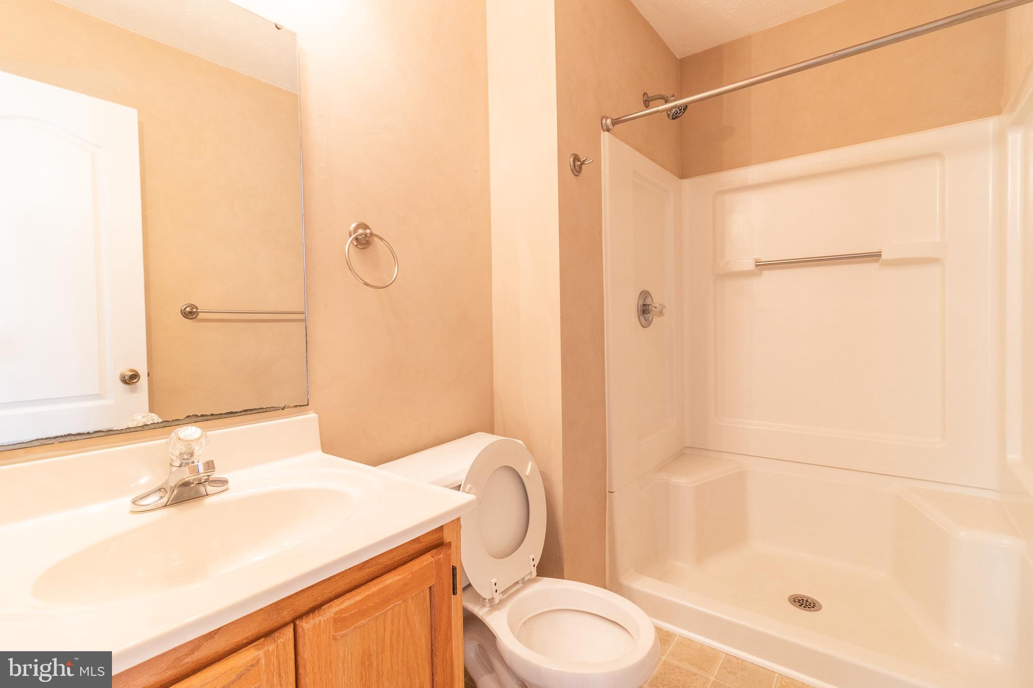 45292 Rumsford Lane California, MD 20619 - Photo 16 of 18 a bathroom with a granite countertop sink toilet and shower