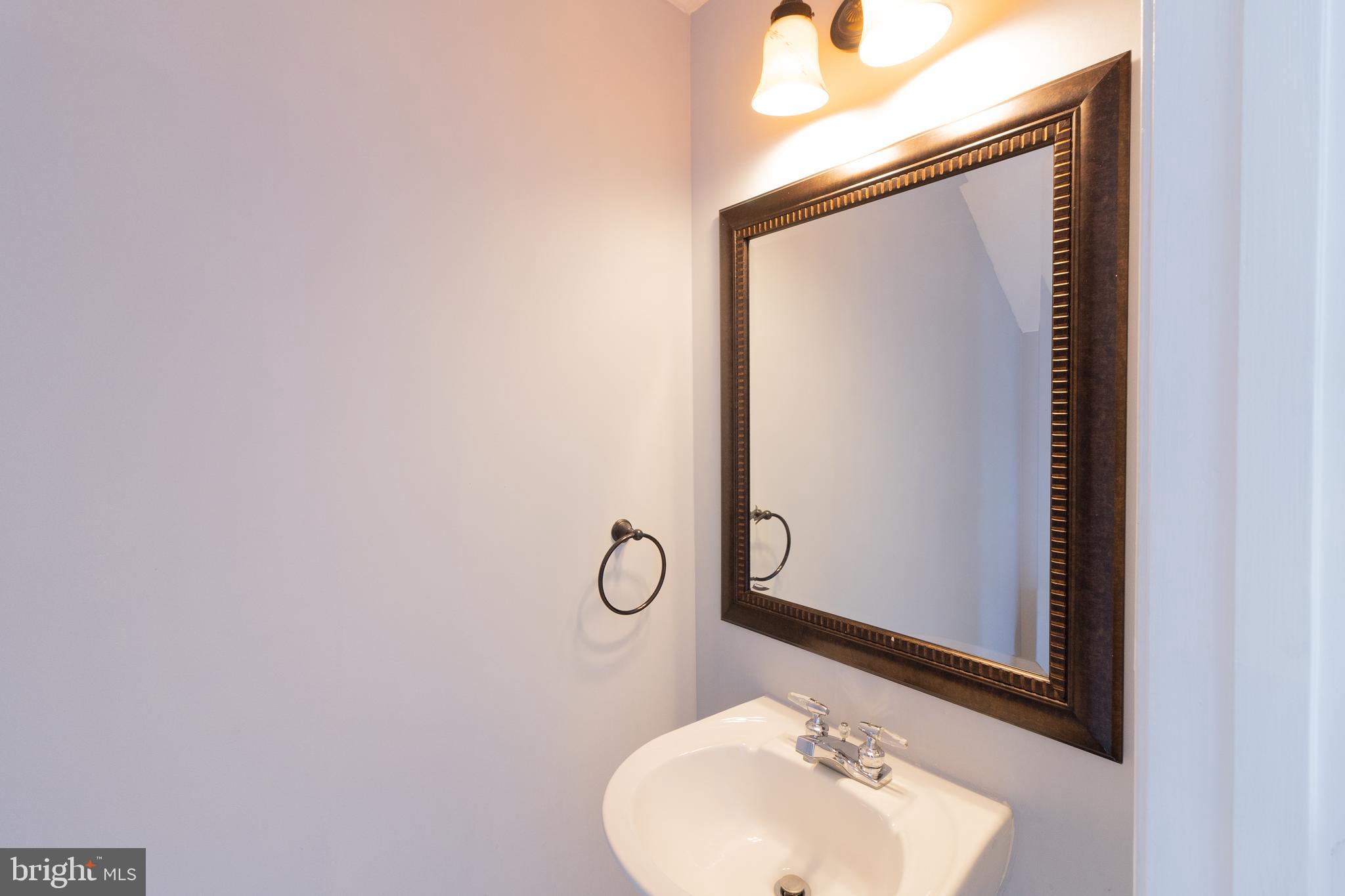 45292 Rumsford Lane California, MD 20619 - Photo 8 of 18 a bathroom with a sink and mirror