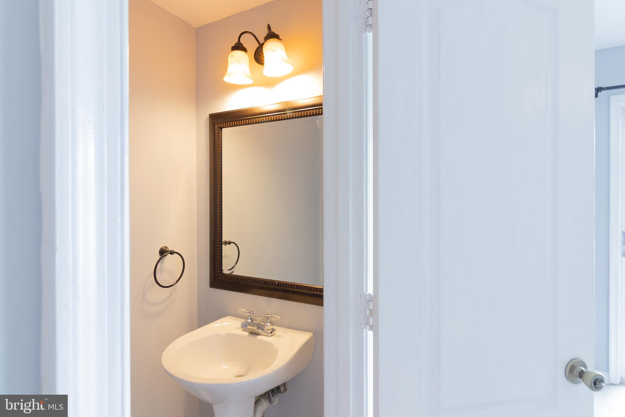 45292 Rumsford Lane California, MD 20619 - Photo 9 of 18 a bathroom with a sink and mirror